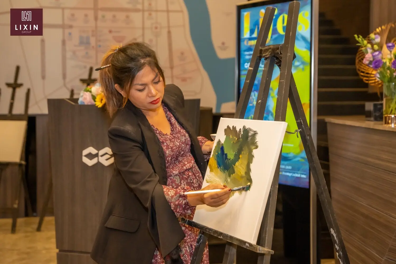 Cambodian artist Dina Chhan creating a live painting at CEO CENTER